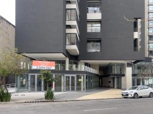 a car parked in front of a building at DNA Vila Mariana - Studios por temporada in Sao Paulo