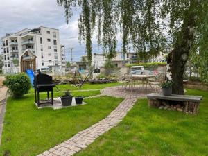 a park with a bench and a piano in the grass at Best-Budged24 in Offenburg