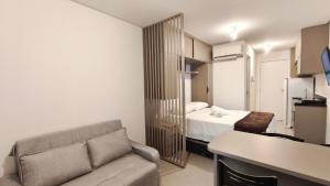 a living room with a couch and a bed at Nawa Residence - Praia de Tamandaré in Tamandaré