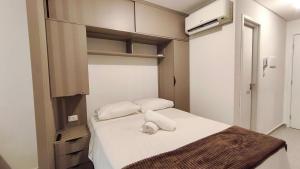 a small room with a bed with two towels on it at Nawa Residence - Praia de Tamandaré in Tamandaré +17 photos