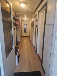 a hallway of a house with a long hallway at Villa Svale, privat og fredelig in Kristiansand