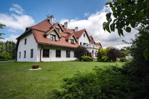 a large white house with a red roof at Apartament ,, Studio '' in Nasutów