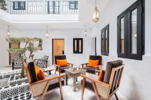 a living room with chairs and a table at Free People Riad and Spa in Marrakesh