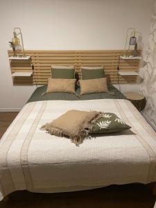 a bedroom with a large bed with a wooden headboard at House in forest proche GR and circuit in Saint-Mars-la-Brière
