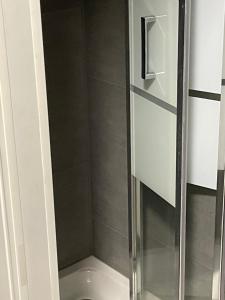 a shower with a glass door in a bathroom at Gîte o prés de la Loire classé 3 étoiles in Ousson-sur-Loire +17 photos