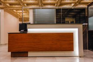 an office with a reception desk in a room at Lataska Hotel in Bahawalpur