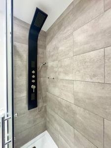 a bathroom with a shower with a shower head at El sueño de mi vida in Caleta De Fuste