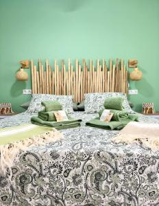 a bedroom with a bed with pillows and a radiator at El sueño de mi vida in Caleta De Fuste