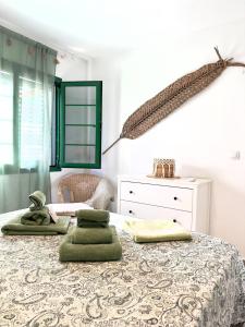 a bedroom with a bed with green pillows on it at El sueño de mi vida in Caleta De Fuste +35 photos