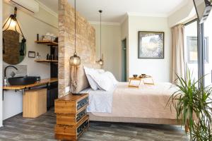 a bedroom with a bed and a sink at Tripiti Cozy Flat in Damnoni