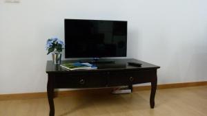 a black table with a television on top of it at Watching Azores Apartment in Ponta Delgada