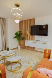 a living room with a flat screen tv on a wall at 44 luxurious Unity homes in Ongata Rongai 