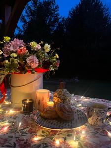a table with a vase of flowers and a candle at Jakubowo in Długi Bród +2 photos
