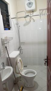 a bathroom with a toilet and a sink at Richie Homes in Kampala