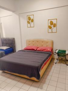 a bedroom with a large bed in a room at Oceanwhite Homestay Corus in Port Dickson