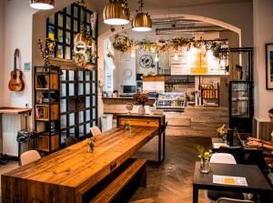 a restaurant with a large wooden table in a room at Prague Dream Hostel in Prague
