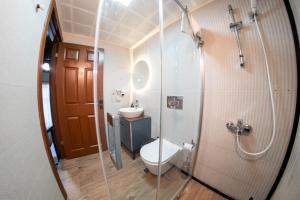 a bathroom with a toilet and a glass shower at Casa Maria Hotel in Antalya +71 photos