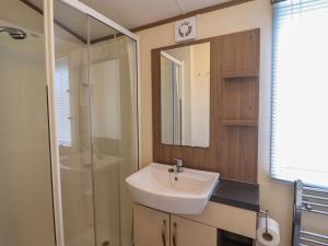 a bathroom with a sink and a shower at Beach Retreat E19 Dyffryn Seaside Estate in Dyffryn +14 photos