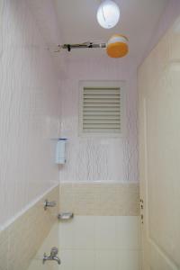 a bathroom with a tub and a sink and a window at 44 luxurious Unity homes in Ongata Rongai 