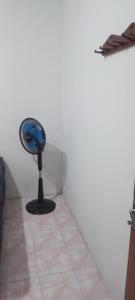 a blue fan sitting in the corner of a room at Bunaken Jhon Homestay in Manado +8 photos