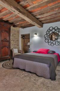 a bedroom with a large bed and a mirror at Domaine d'AROMM - Chambres d'hotes & gites - Piscine, Jacuzzi, Etangs & Animaux - Au calme in Ouches +85 photos