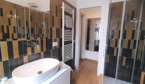 a bathroom with a white sink and a mirror at Rooftop View Città della Pieve in Città della Pieve +16 photos