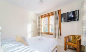 Ένα ή περισσότερα κρεβάτια σε δωμάτιο στο Fitzys Apartment Wellness Retreat