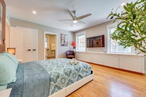a bedroom with a bed and a flat screen tv at 1 Mi to UF Campus Group Retreat with Outdoor Oasis in Gainesville
