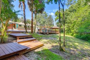 a backyard with a wooden deck and a gazebo at 1 Mi to UF Campus Group Retreat with Outdoor Oasis in Gainesville