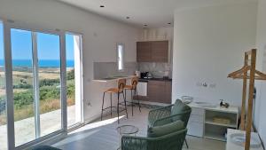 a living room with a kitchen with a view of the ocean at Parthenope in Petacciato