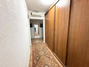 an empty hallway with a rug on the floor at Dni apartment in Bucharest +4 photos