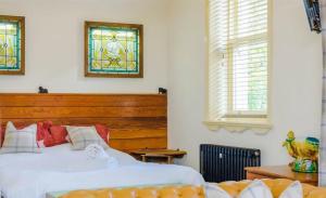 a bedroom with two beds and stained glass windows at Fitzys Coach House - Wellness Retreat  +88 photos