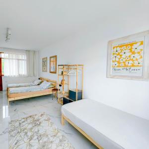 two beds in a room with white walls at Erendiz Garden Hotel in Kemer +245 photos