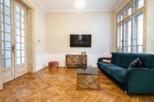 a living room with a couch and a tv at Lascăr Catargiu Villa in Bucharest