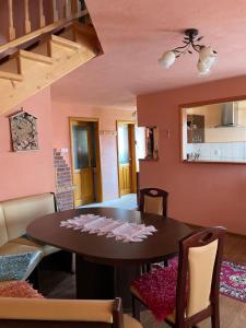 a dining room with a table and chairs at Ambrus vendégház in Gheorgheni +17 photos