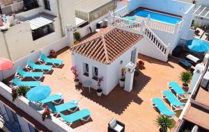 an aerial view of a house with chairs and a swimming pool at Las Flores Apartments in Nerja