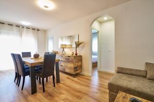 a living room with a table and chairs and a couch at Oscars in Les Cases d'Alcanar +5 photos