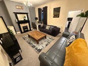 a living room with a couch and a coffee table at Oswaldtwistle Spacious 3-Bedroom/Two Bath in Oswaldtwistle
