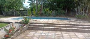 a backyard with a swimming pool and a garden at Rancho PÔR do Sol in Benevides