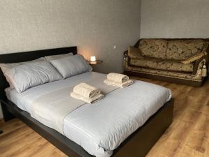 a bedroom with a large bed with towels on it at Quiet Comfortable Stay - Energetiku g 32, Visaginas in Visaginas