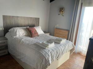 a bedroom with a bed with pillows on it at Txatonea 
