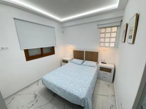 a small bedroom with a bed and a window at Cozy Apartment with Wi-Fi in Costa de Adeje