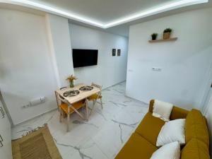 a living room with a couch and a table at Cozy Apartment with Wi-Fi in Costa de Adeje