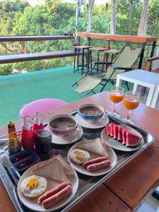 a tray with eggs and bread and drinks on a table at ลุงพล โฮมสเตย์ เชียงดาว in Chiang Dao