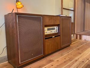 a large wooden entertainment center with a radio at 山二 -Yamafu in Imizu