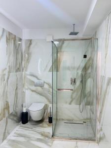 a bathroom with a shower and a toilet at White Titanic -Luxury Turism in Mamaia Sat/Năvodari +49 photos