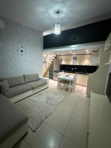 a living room with a couch and a table at DS Apartment Grand Europa Resort in Velipojë