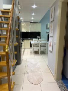 a kitchen and dining room with a spiral staircase at DS Apartment Grand Europa Resort in Velipojë +2 photos
