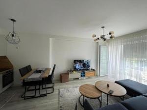 a living room with a couch and a table at Lili's Cozy Apartment in Pristina