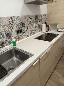 a kitchen with a sink and a counter top at El Apartamento de Hervás in Hervás